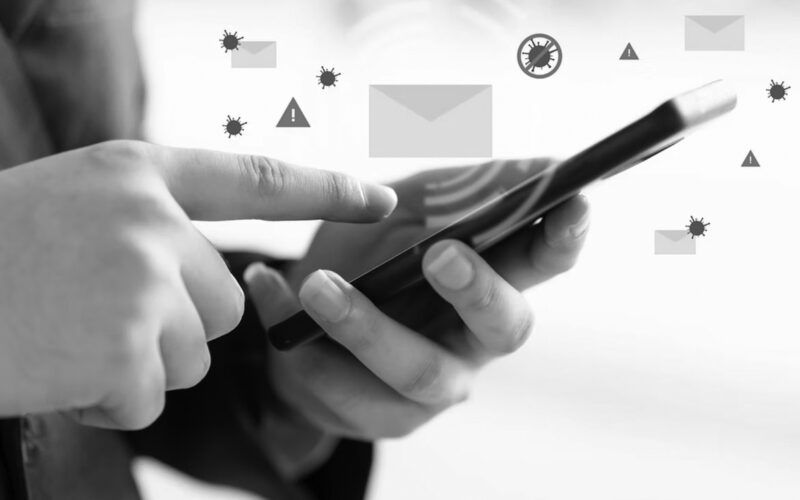 A person uses a smartphone, with illustrated email icons, warning signs, and virus symbols appearing above the device, highlighting the need for phishing training to improve email security and enhance phishing prevention.